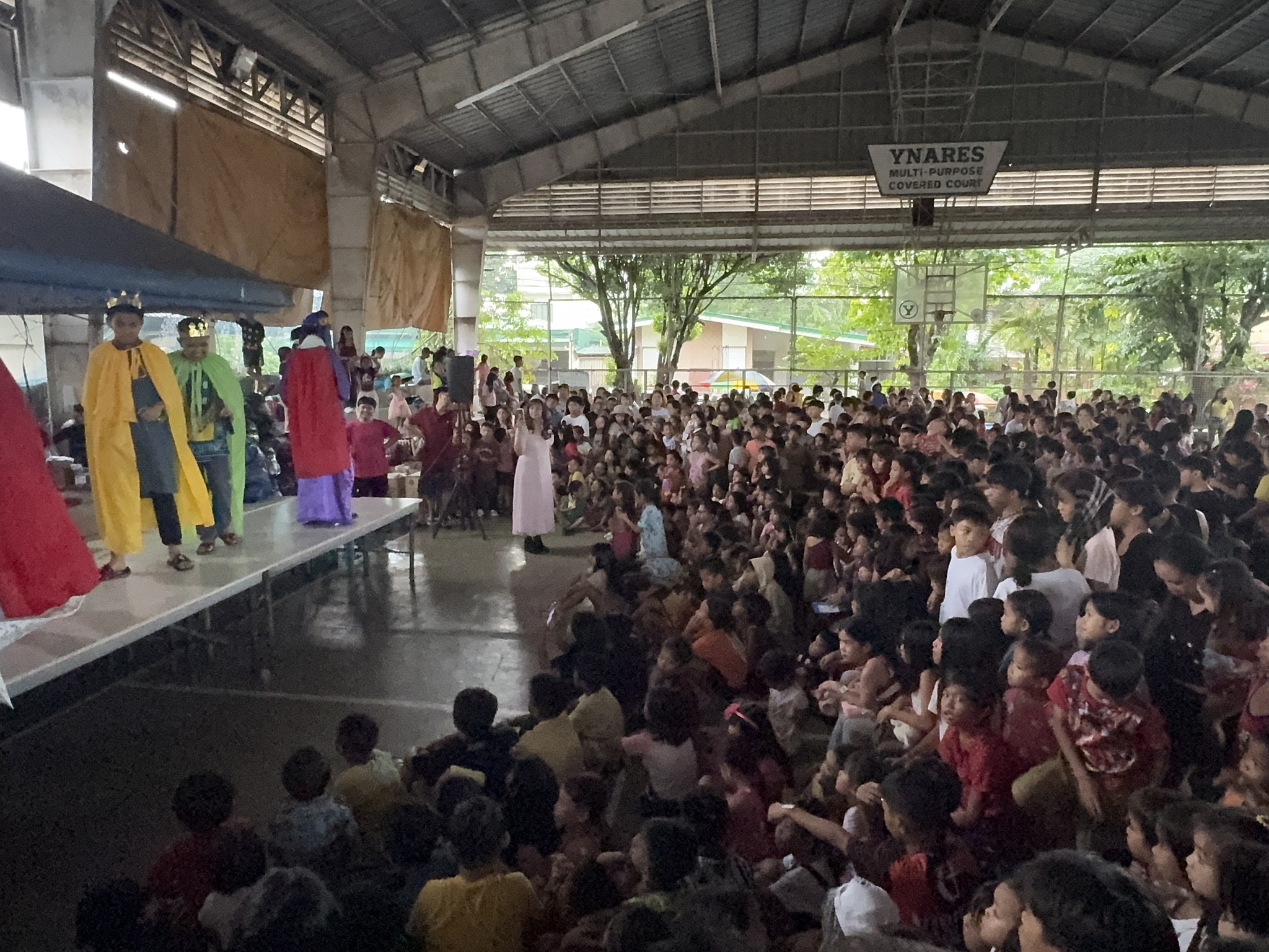 Wide shot of stage performance showing the full scale of the crowd at Superkids Christmas Party