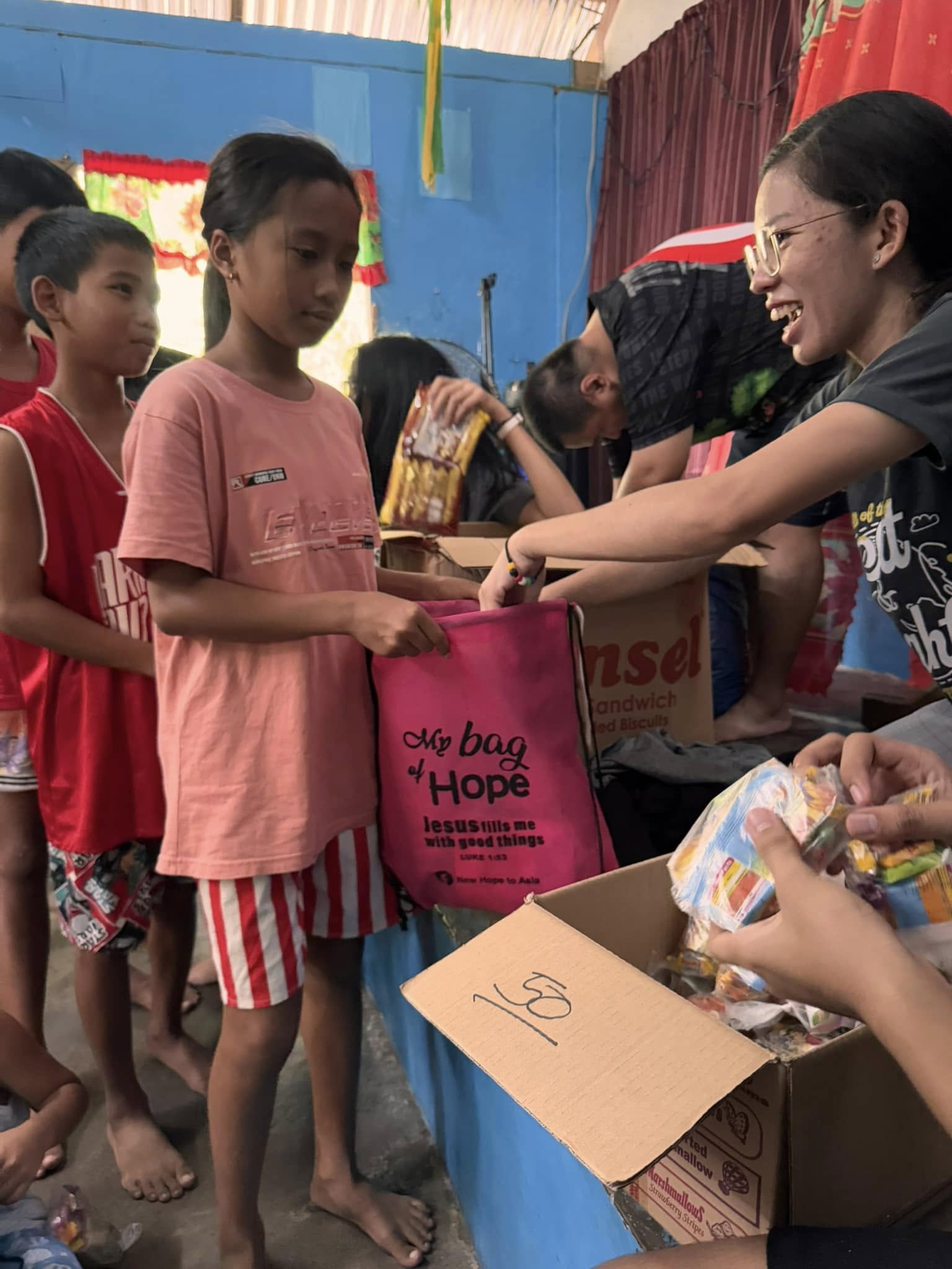 A girl receiving a pink My Bag of Hope
