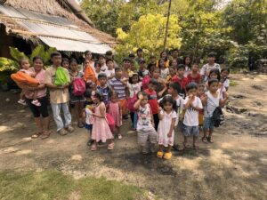 Children of New Hope Pitogo gathered outside holding their colorful Bags of Hope