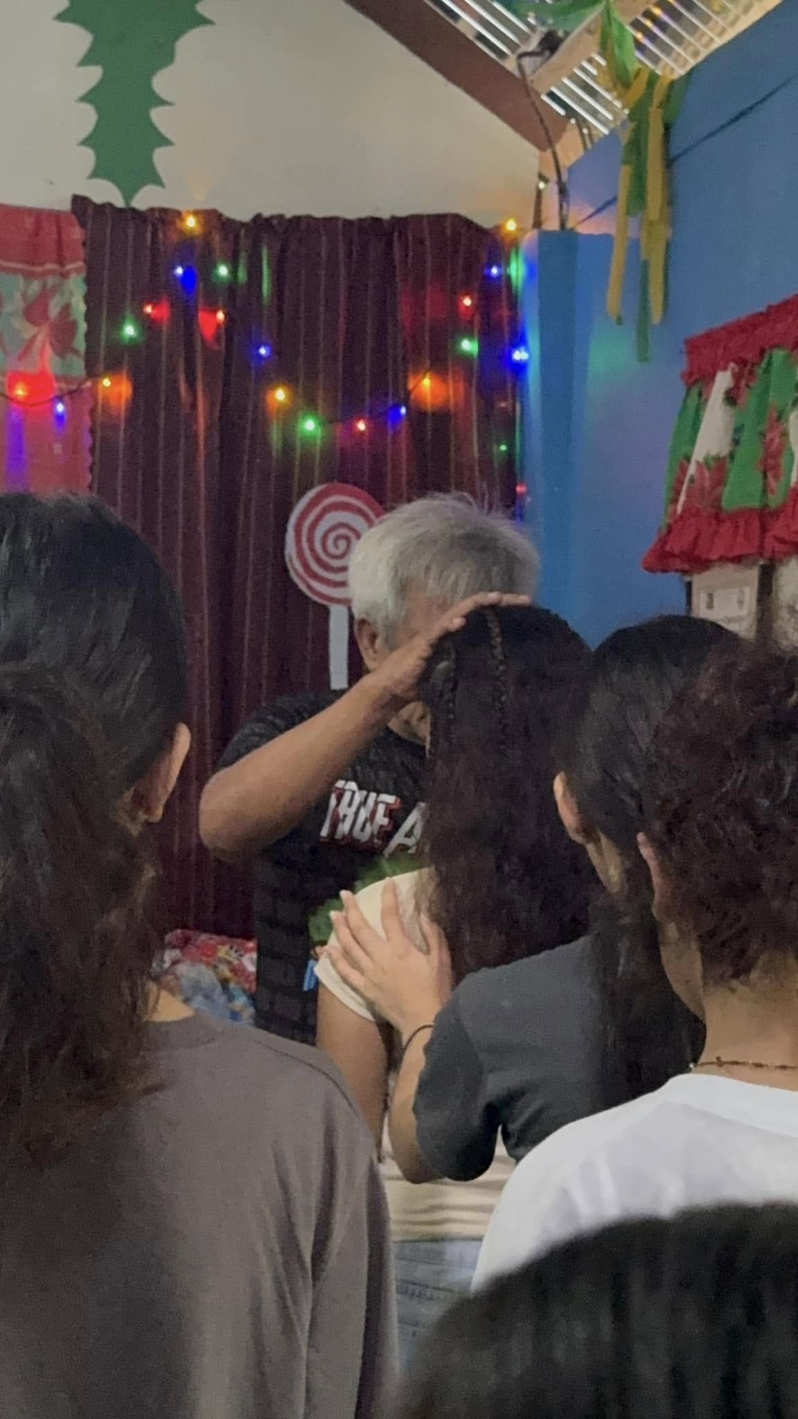 Pastor praying over the teens at New Hope Pitogo