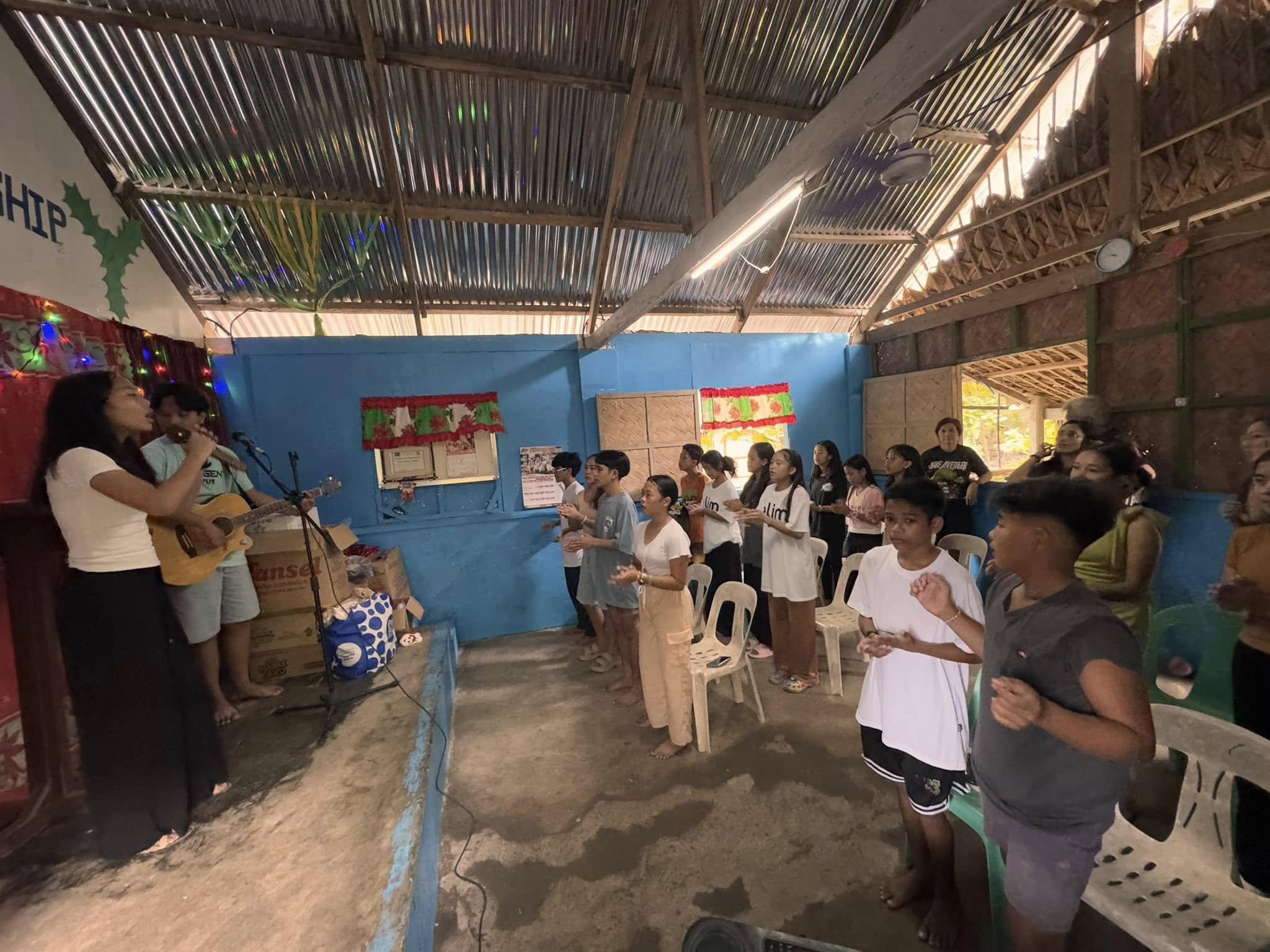 Teens worshipping together with guitar at New Hope Pitogo