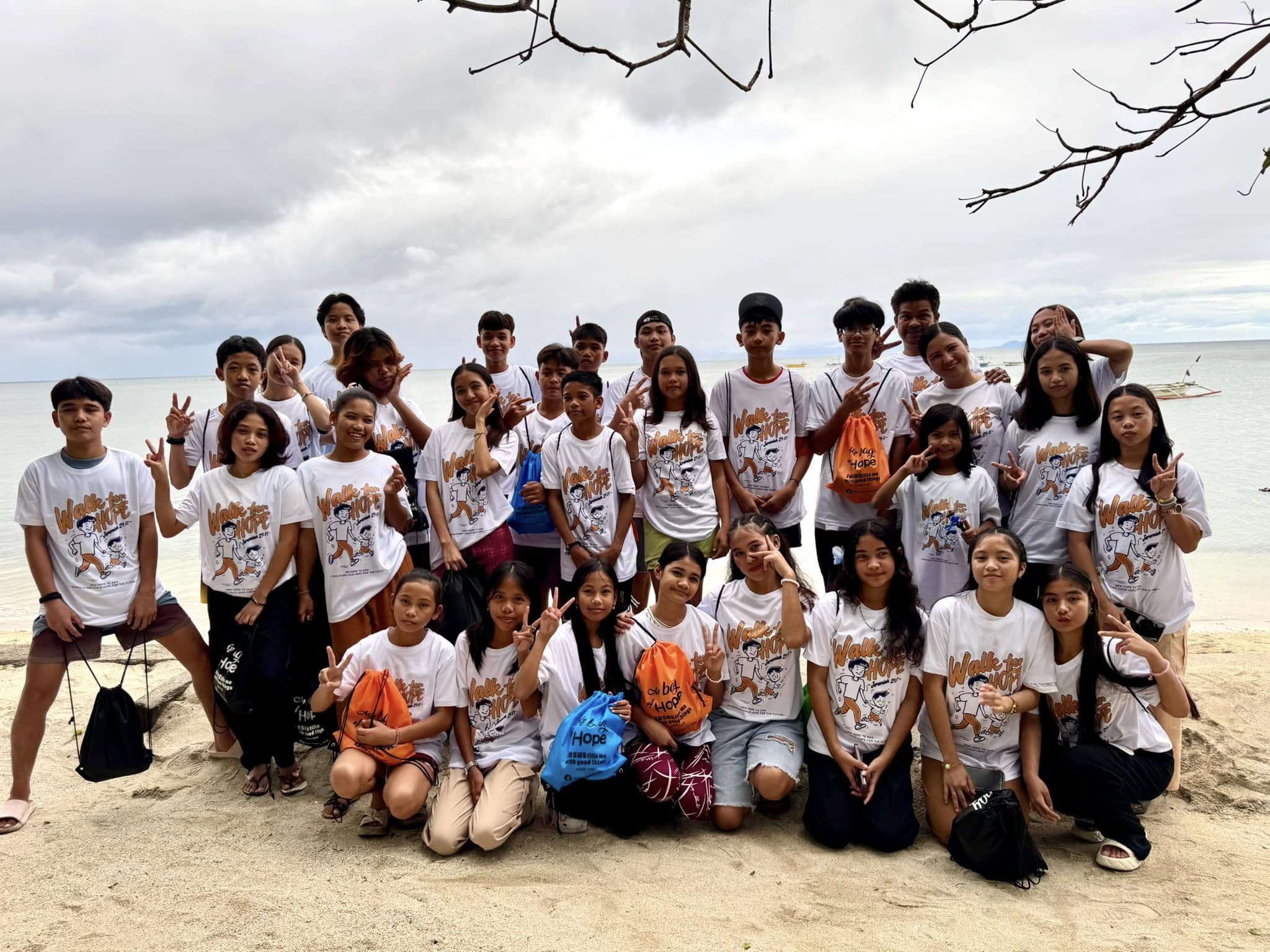 Youth of New Hope Pitogo wearing Walk for Hope shirts at the beach